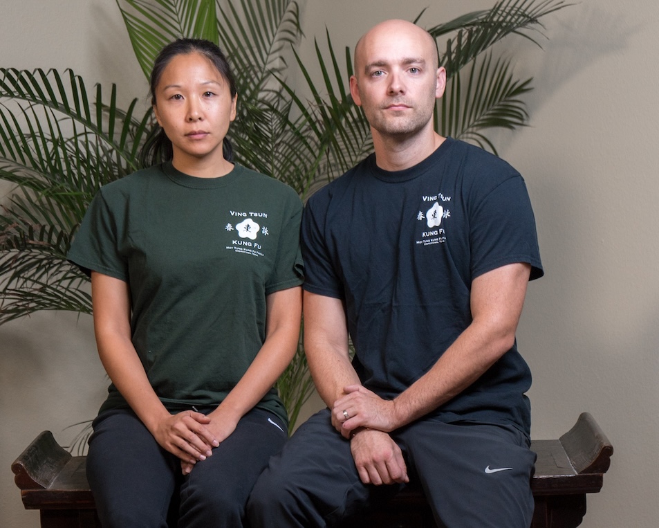 Sifu BeeBee Bartell and Sifu Nic Bartell seated together in school training shirts